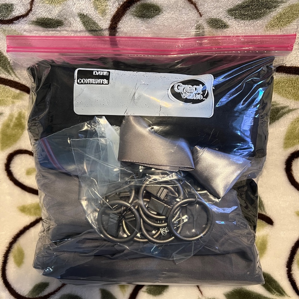 Sheer curtain panels in gray and black with silver clip rings